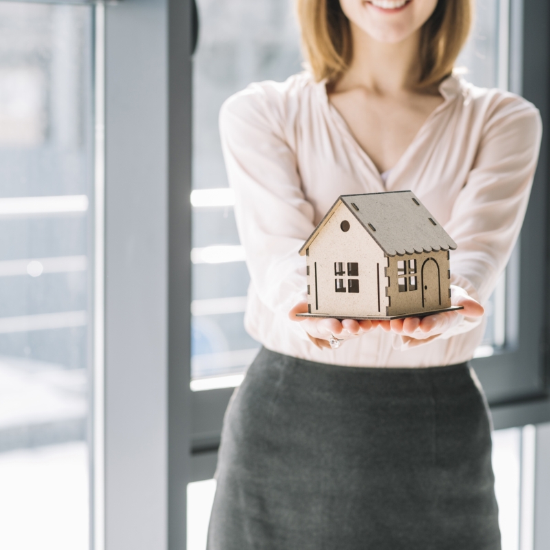 crop-woman-holding-nice-toy-house